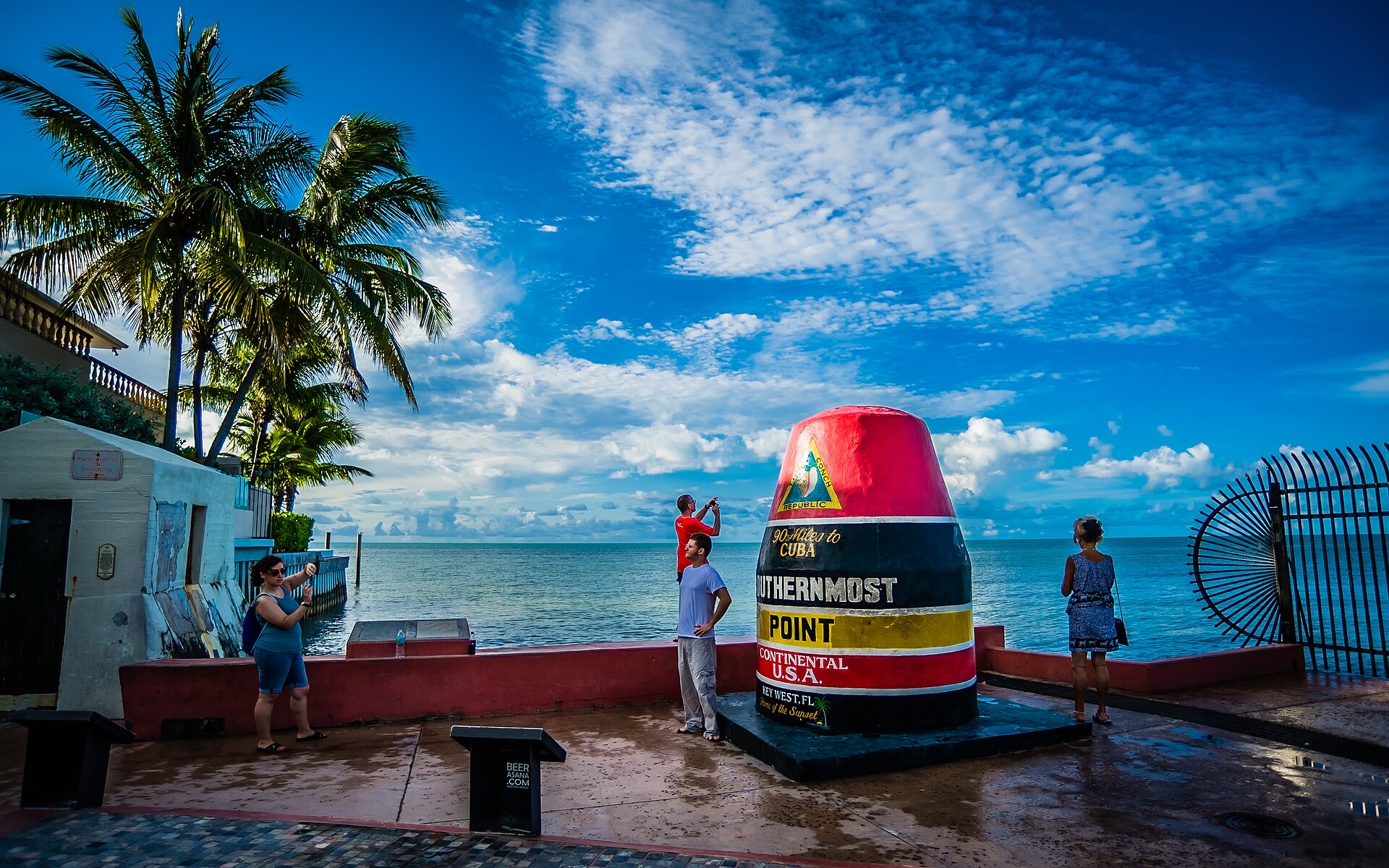 The Southernmost Point buoy in Key West with the sea behind it